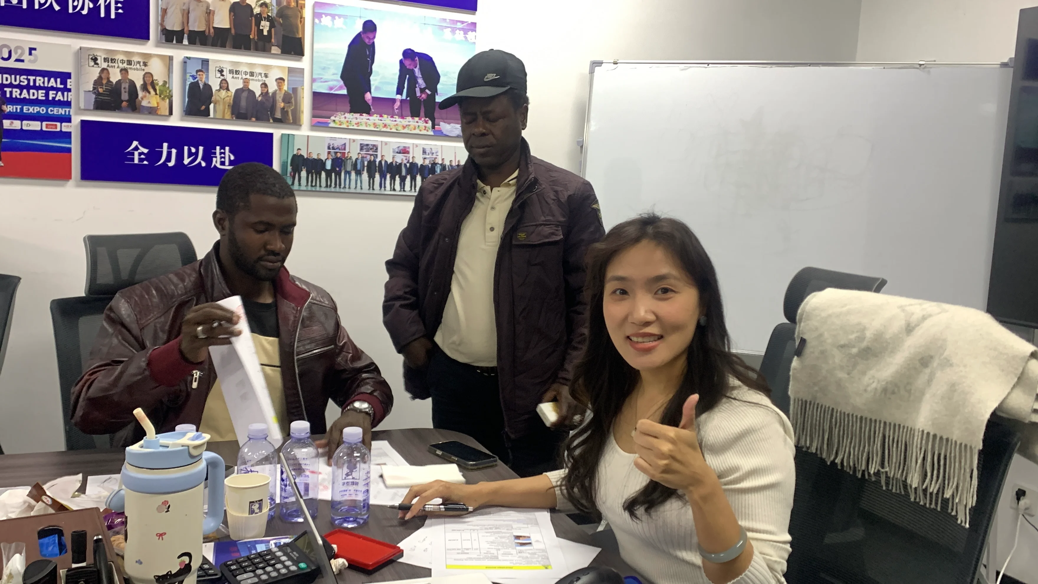 African customers confirming truck order during business meeting in China